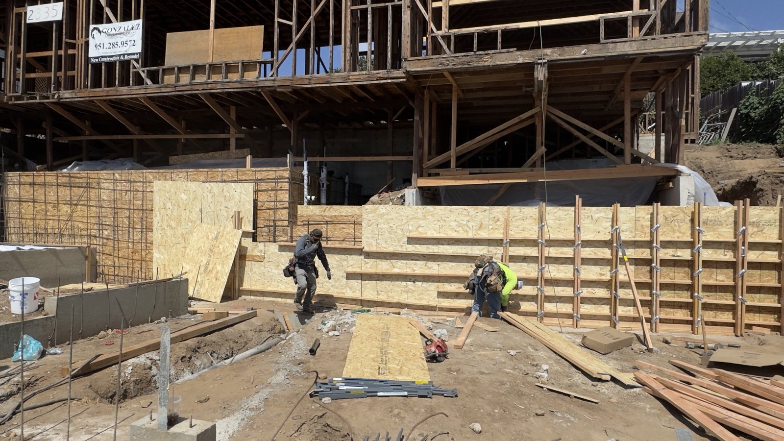 Front retaining wall formed — September 2026