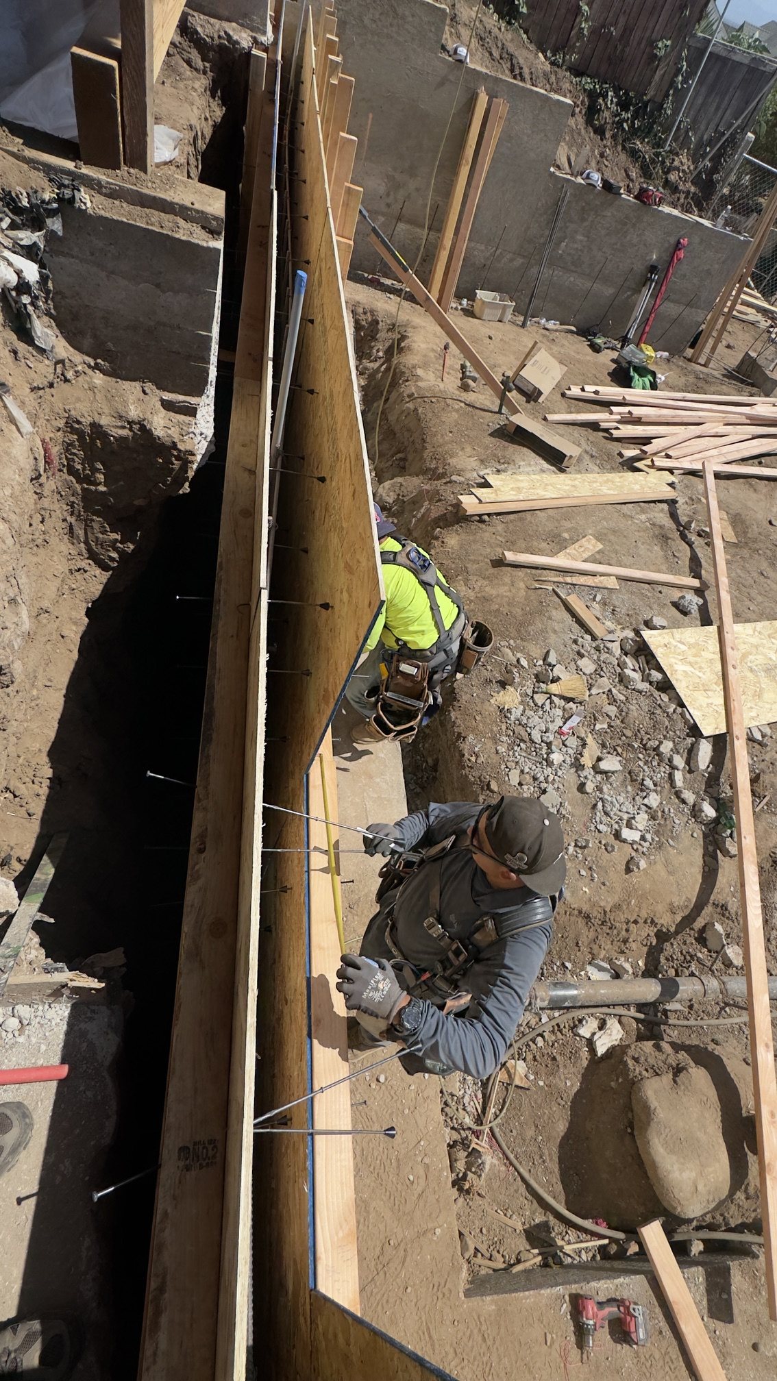 Front retaining wall formed — September 2026